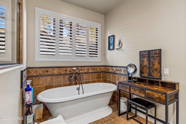 bathroom with tile walls, tile patterned floors, and a bath