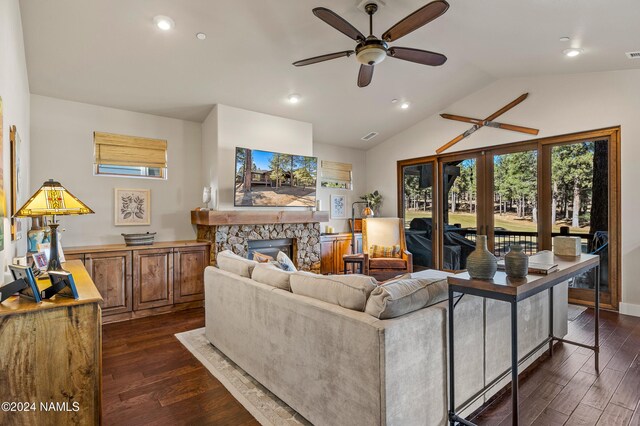 living room with ceiling fan, dark hardwood / wood-style flooring, a fireplace, and lofted ceiling