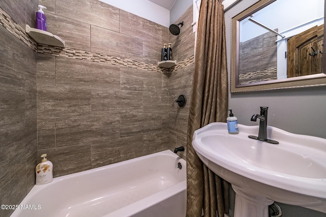 bathroom featuring a sink and shower / bath combo with shower curtain