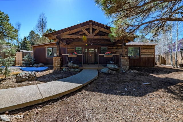 rear view of property featuring fence