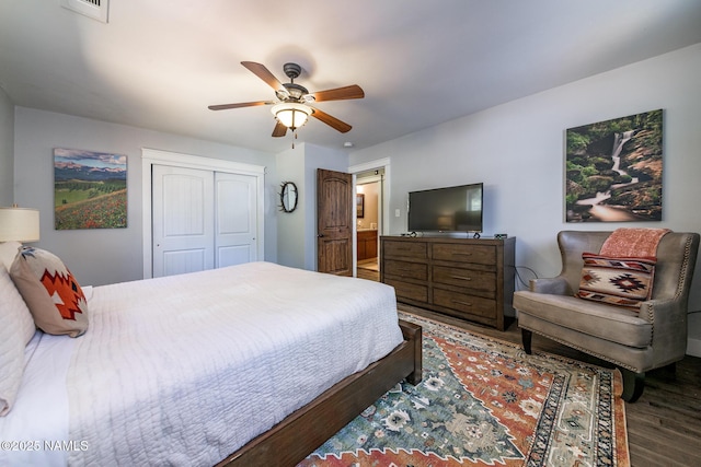 bedroom featuring a closet, wood finished floors, visible vents, and a ceiling fan