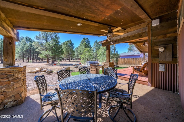 view of patio / terrace with outdoor dining area, ceiling fan, area for grilling, and fence