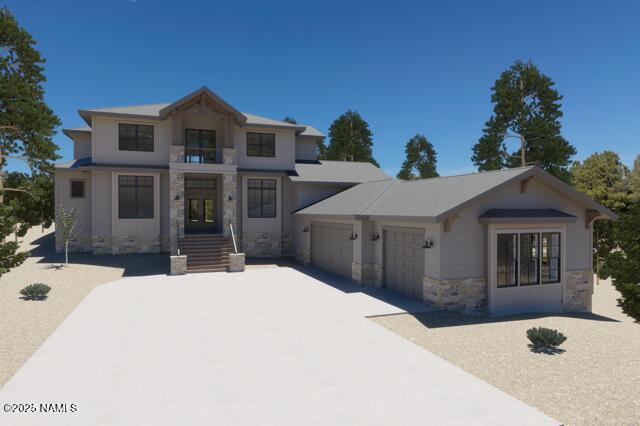3515 Lariat Loop, Flagstaff, AZ 86005 - view of front facade with stone siding, an attached garage, and concrete driveway