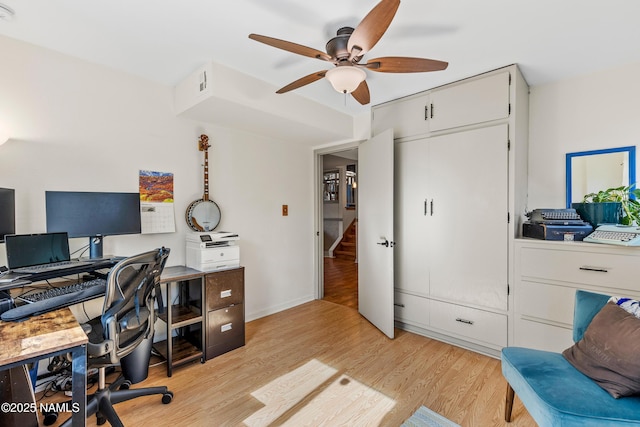 home office with ceiling fan and light wood-type flooring