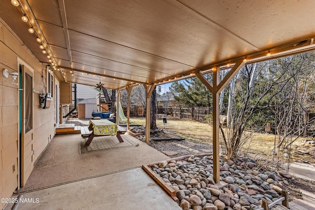 view of patio with a storage unit