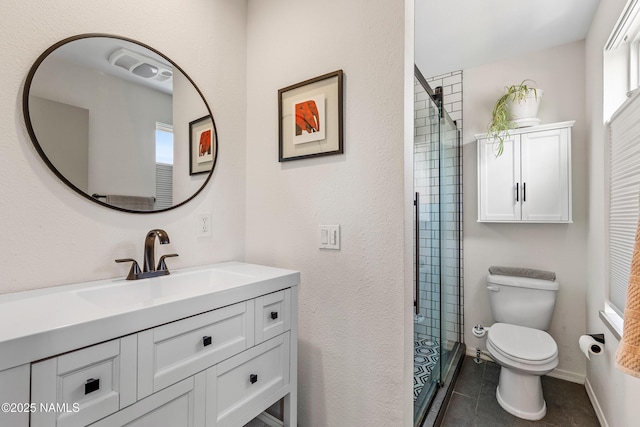 bathroom with a tile shower, vanity, toilet, and tile patterned flooring