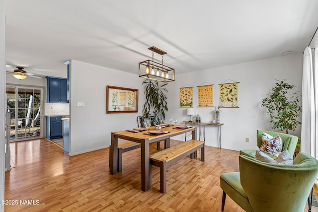 dining area featuring ceiling fan with notable chandelier and light hardwood / wood-style floors