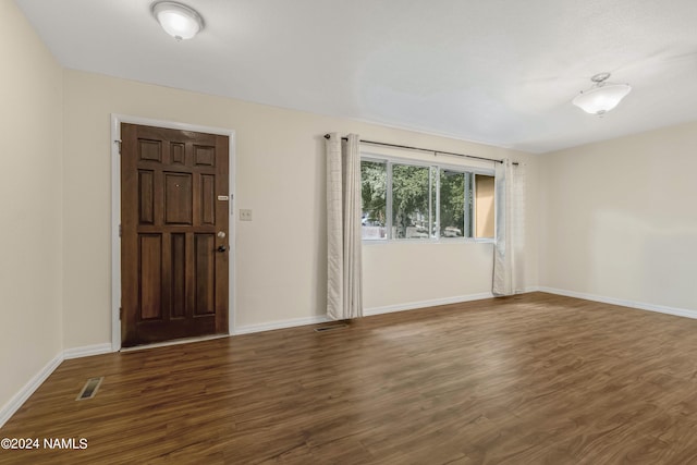 spare room featuring dark hardwood / wood-style floors