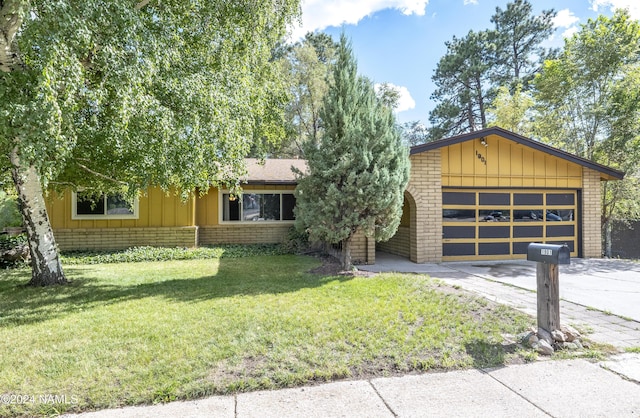 ranch-style home featuring a garage and a front lawn