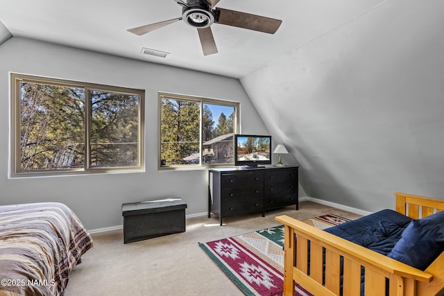 carpeted bedroom featuring visible vents, baseboards, ceiling fan, and vaulted ceiling