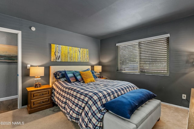 bedroom featuring baseboards and carpet