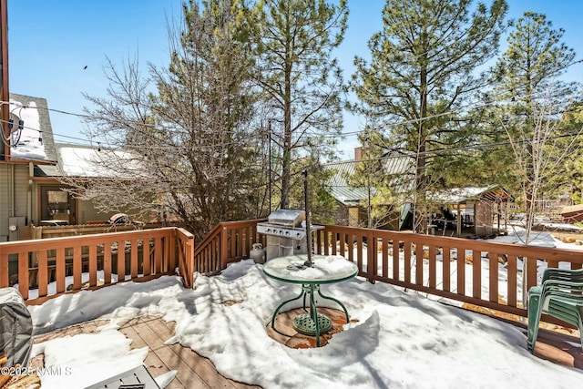 snow covered deck featuring grilling area