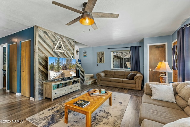 living room featuring a ceiling fan, wood finished floors, and baseboards