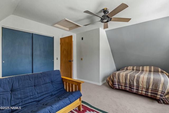 bedroom featuring a ceiling fan, carpet, baseboards, attic access, and a closet