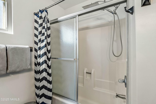 bathroom featuring shower / bath combination with glass door