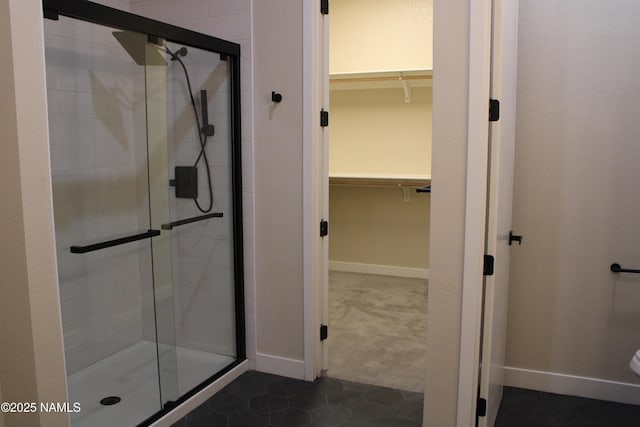 bathroom featuring an enclosed shower and tile patterned floors