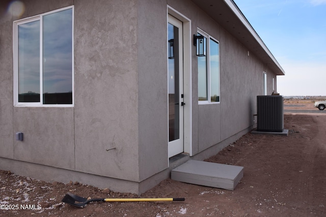 view of side of property featuring central AC