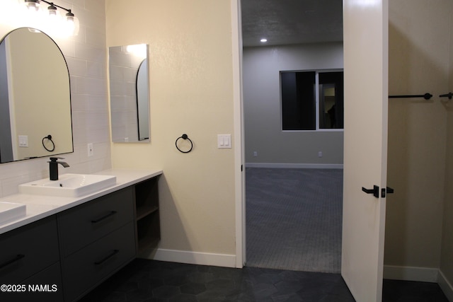 bathroom with tasteful backsplash, vanity, and tile patterned flooring