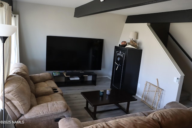 living room with beam ceiling and dark wood-type flooring