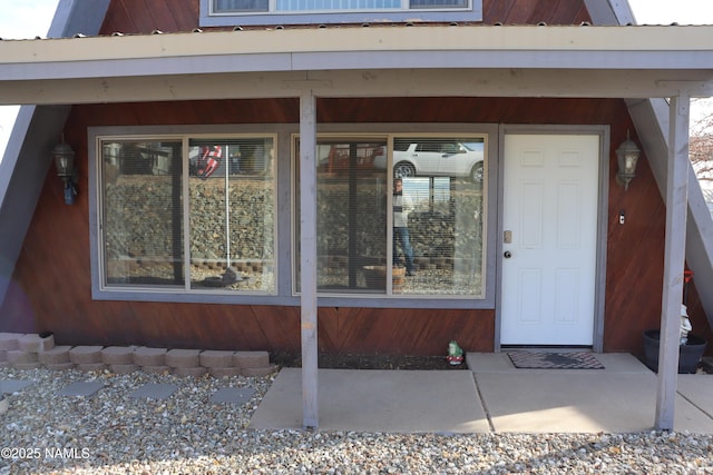 doorway to property featuring covered porch