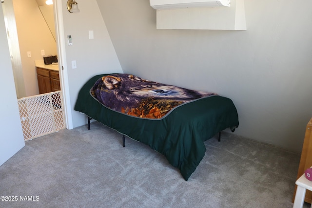 bedroom featuring a wall unit AC and carpet flooring