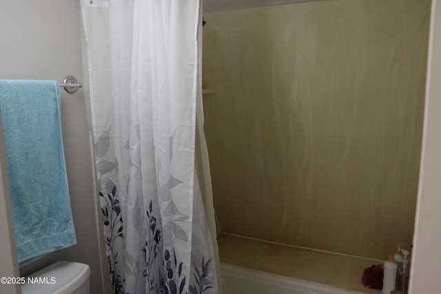 bathroom featuring toilet and a shower with shower curtain