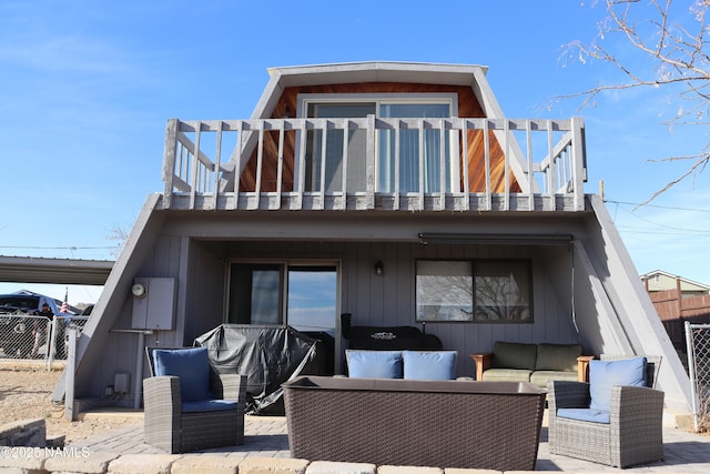 back of house with a balcony and outdoor lounge area