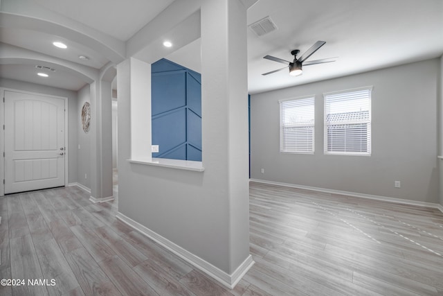 corridor with light hardwood / wood-style floors