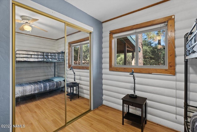 bedroom with ceiling fan, hardwood / wood-style floors, and a closet