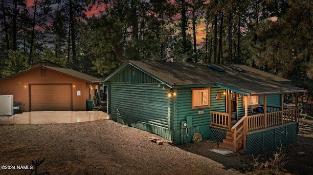 view of front of home with a garage and an outdoor structure