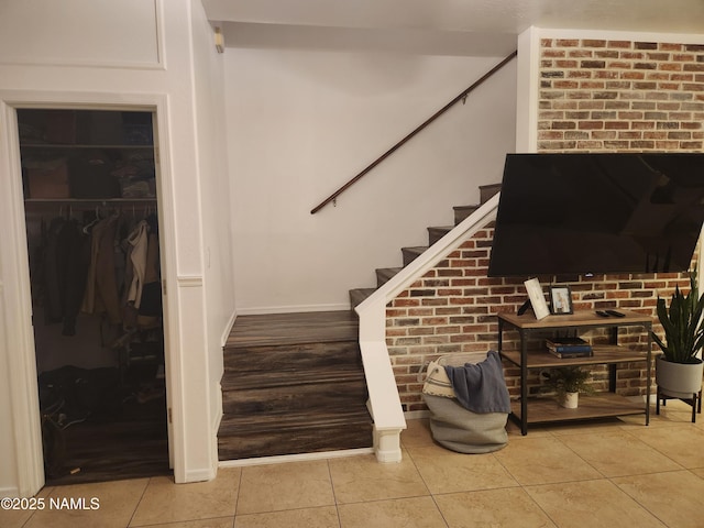 stairs featuring baseboards and tile patterned floors