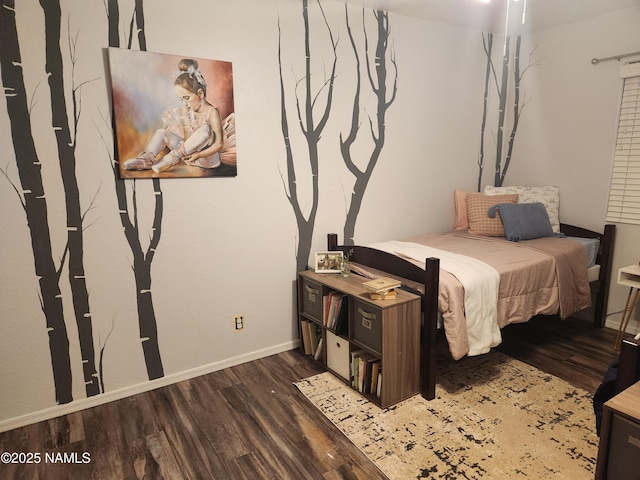 bedroom featuring baseboards and wood finished floors