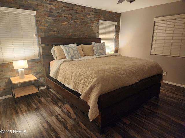 bedroom with wood finished floors and baseboards