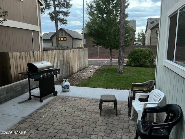 view of patio with area for grilling and a fenced backyard