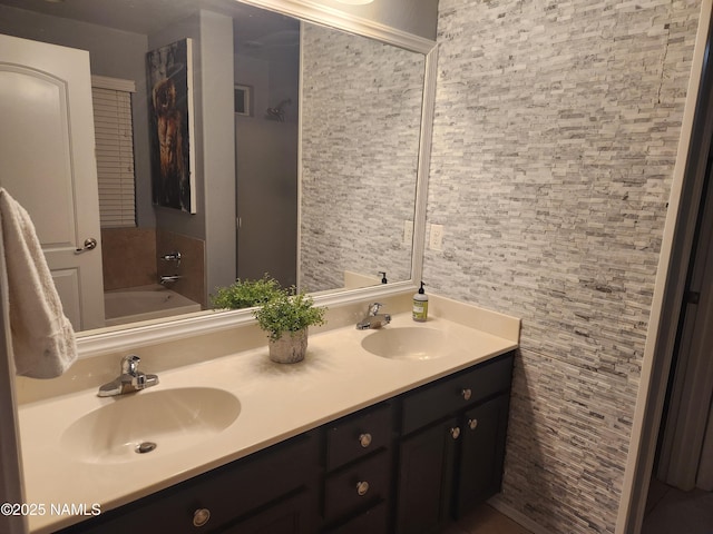 bathroom featuring double vanity, a sink, and a bath