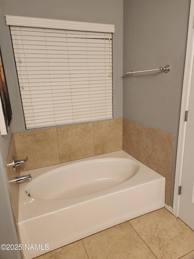 bathroom featuring a garden tub and tile patterned floors