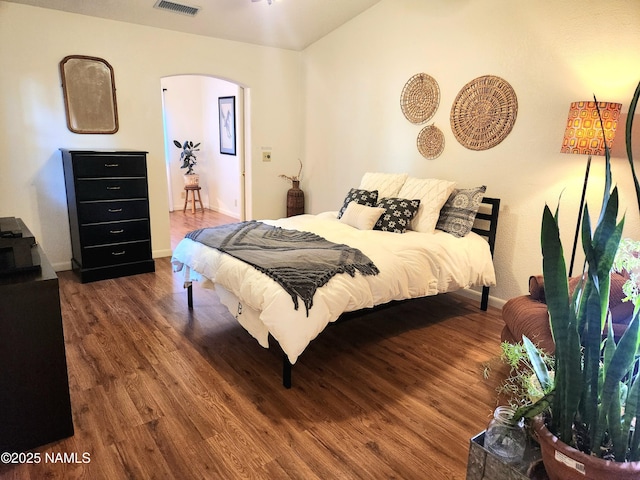 bedroom with dark wood-type flooring