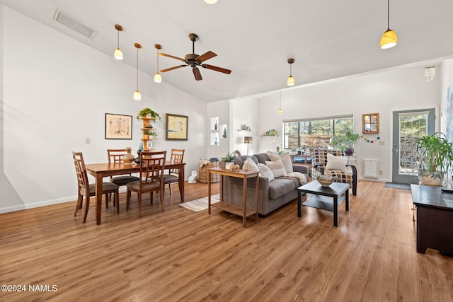 living room featuring light hardwood / wood-style floors, high vaulted ceiling, and ceiling fan