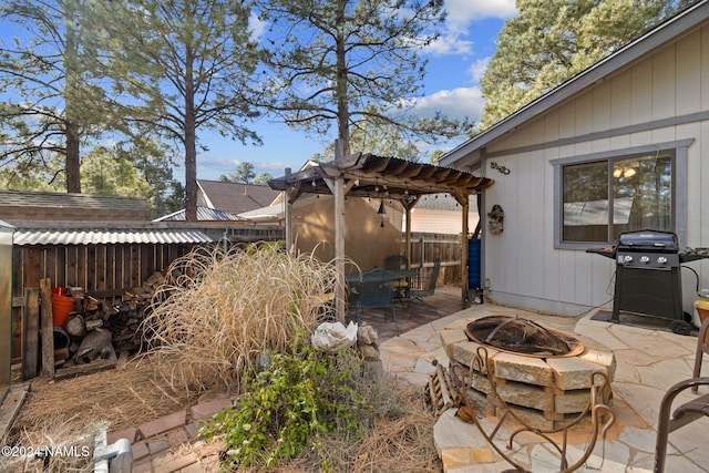 view of patio / terrace with a pergola, grilling area, and a fire pit