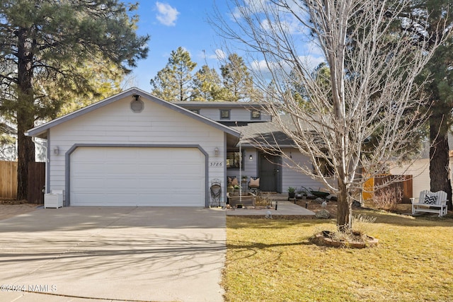 view of front of house with a garage and a front lawn