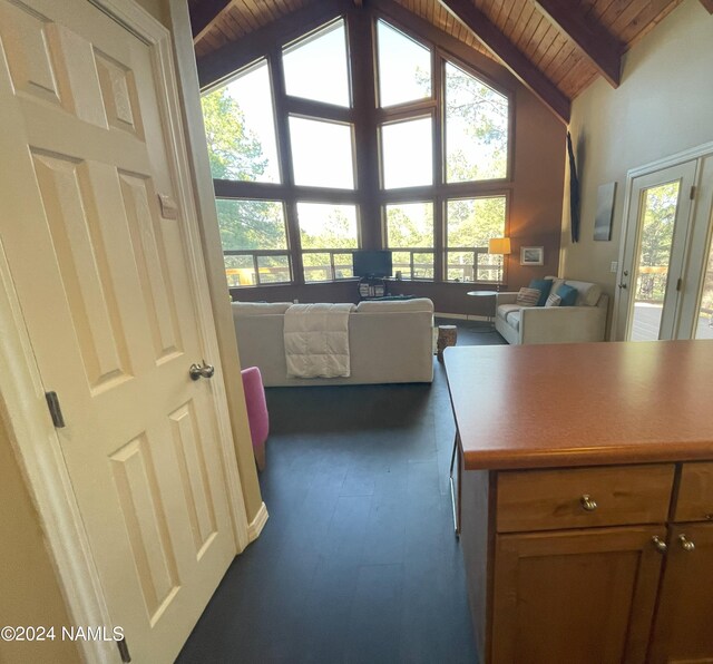 interior space featuring high vaulted ceiling, wooden ceiling, dark hardwood / wood-style floors, and beam ceiling