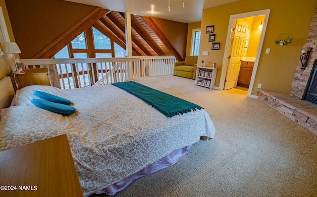 carpeted bedroom featuring ensuite bath, a stone fireplace, wooden ceiling, and lofted ceiling with beams