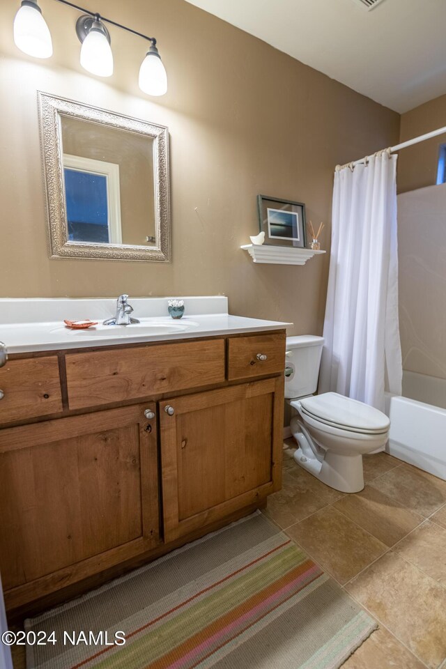 full bathroom with toilet, shower / tub combo, tile patterned floors, and vanity