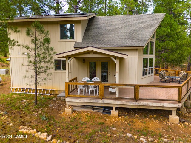 rear view of house featuring french doors and a wooden deck