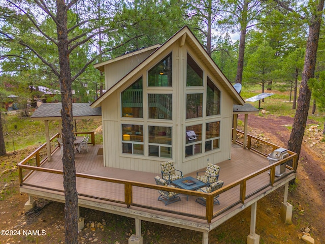 rear view of property with a wooden deck