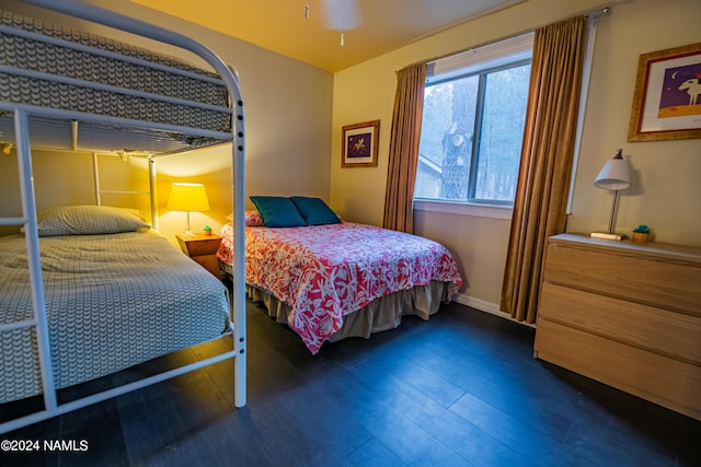 bedroom with dark hardwood / wood-style floors