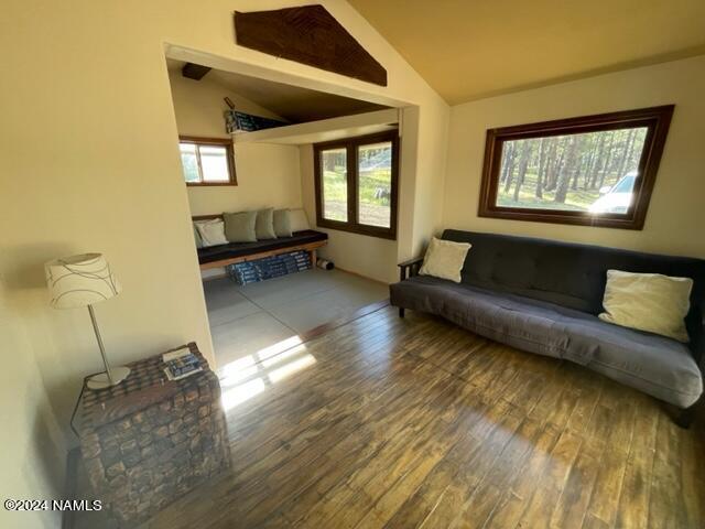 living room featuring hardwood / wood-style flooring and lofted ceiling