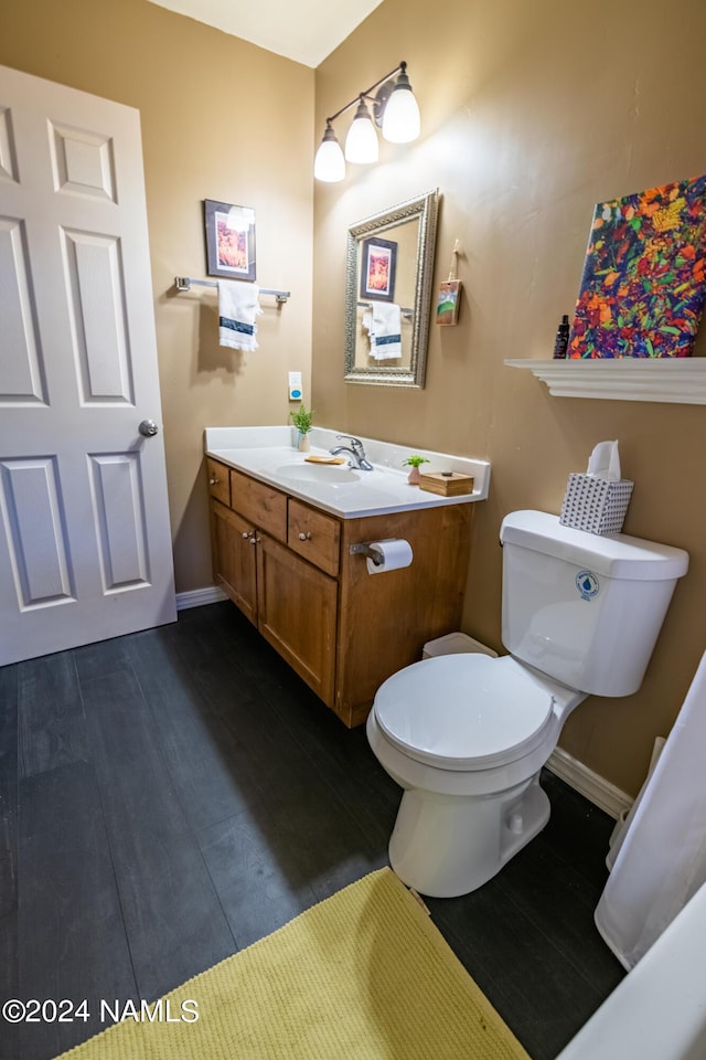 bathroom featuring vanity, toilet, and wood-type flooring