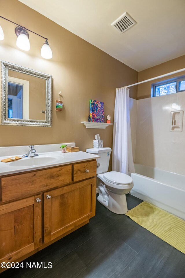 full bathroom with vanity, toilet, and shower / bath combo