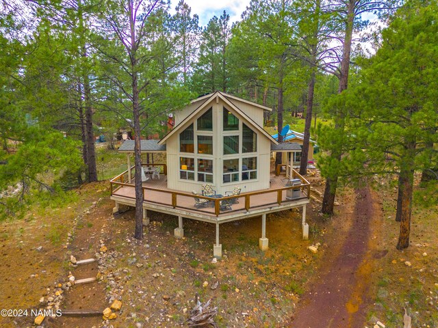 back of house with a wooden deck